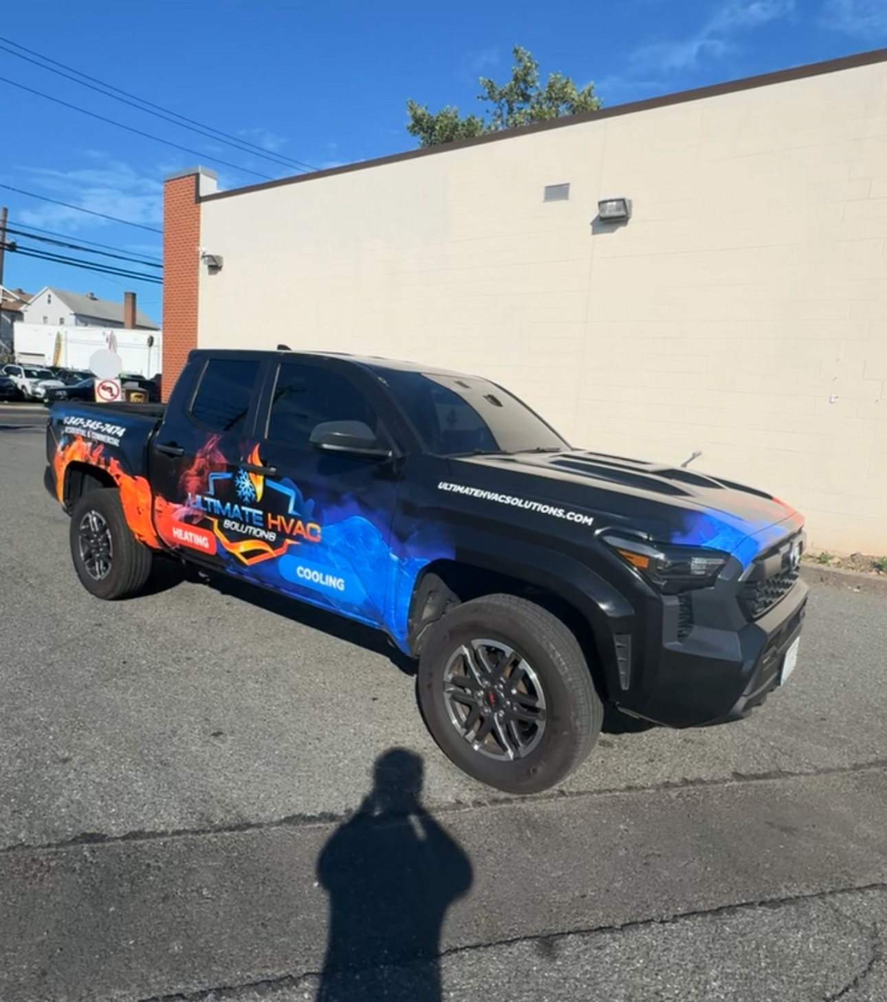Black pickup truck with Ultimate HVAC Solutions flame and ice wrap